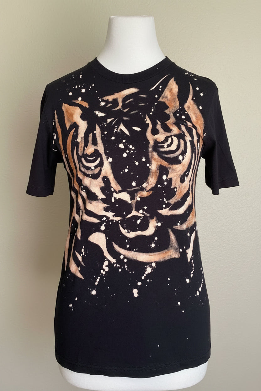 Black t-shirt with a tiger design on a mannequin against a beige background