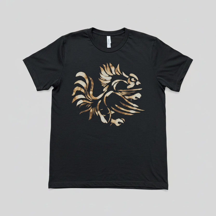 A black short-sleeve t-shirt with a stylized graphic of a rooster in gold and rust tones, laid flat on a light  background.