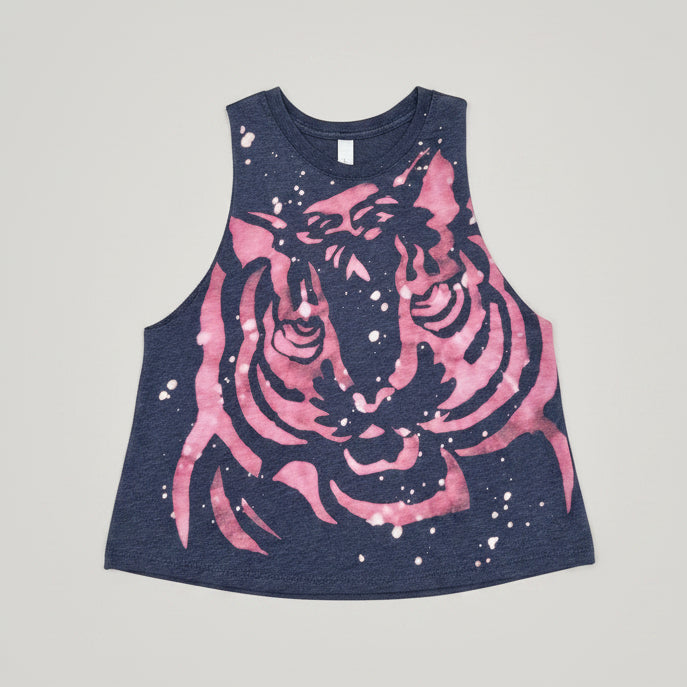 A sleeveless heather navy tank top featuring a large pink tiger face graphic with white splatter details, laid flat on a light gray surface.