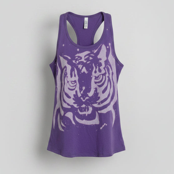 A purple racerback tank top featuring a large white tiger graphic on the front, displayed against a neutral light gray background.