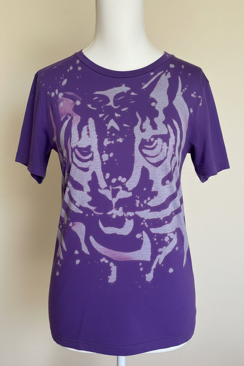 Purple t-shirt with a tiger design on a mannequin against a beige background